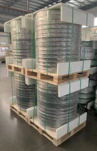 An image of Glass Fiber PP Tapes neatly packaged on a pallet, wrapped in protective plastic film.