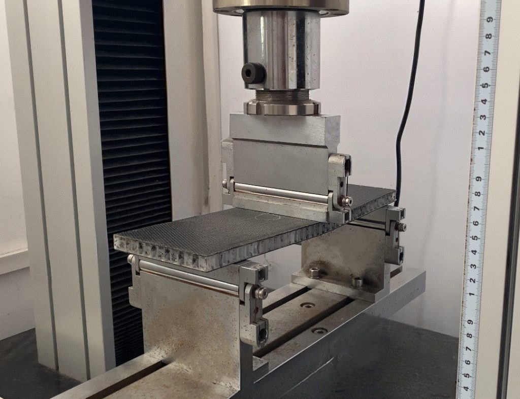 Image of a composite scaffold board undergoing a three-point bending test.